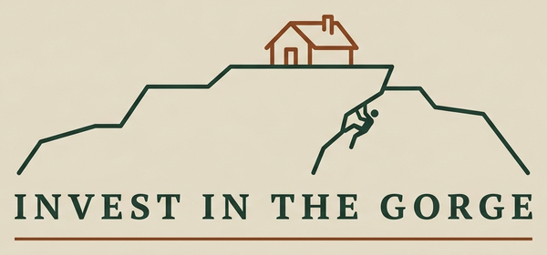 Invest in the Gorge — cliff ridge with a cabin and a rock climber